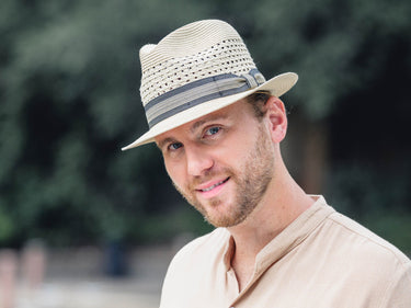 Man wearing a stylish Bayside Braid Hat, showcasing its casual elegance and UV protection.